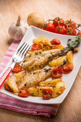 monkfish with potatoes and tomatoes, selective focus