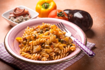 pasta with eggplant capers anchovies and capsicum, selective focus
