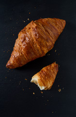 fresh croissant on black stone background