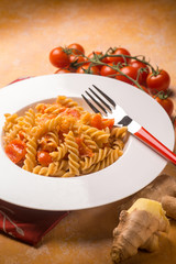 pasta with fresh tomatoes and grated ginger, selective focus