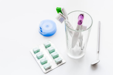 Tools for oral cavity hygiene. Gum, dental mirror, brushes on white background copy space