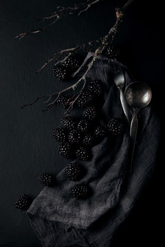 monochrome food picture of blackberries on a napkin and slate plate kitchen table can be used as background