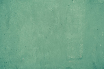Old shabby painted in turquoise, green color wall, grunge background, texture