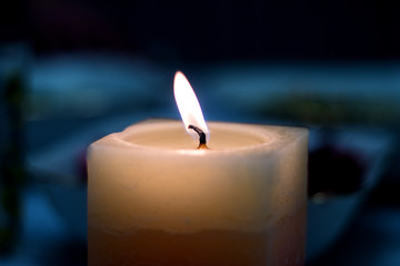 Candle burn on the dark blue background