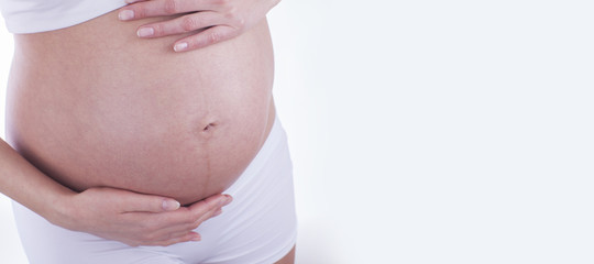 The picture of baby bump isolated on white background. The happiness of waiting for a new family member.
