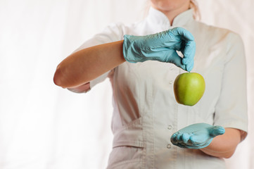 A medical girl holding a green apple