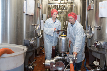 scientists working with large vat in the lab
