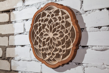 the layers of the mandala are cut from a tree by a laser