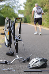 Naklejka premium Man walking off leaving broken bicycle