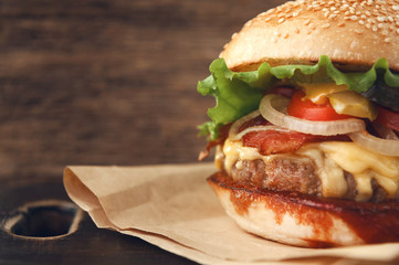 mouth-watering delicious homemade burger used to chop beef on the wooden table.