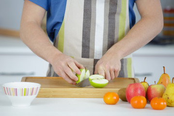 apples cut on a white plate on wooden table