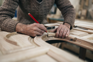 Close up shot of old master carpenter working in his woodwork or workshop