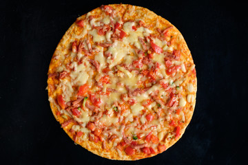 pizza on black background top view