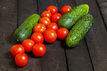 tomatoes and cucumbers are on the table