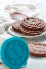 Chocolate cookie and stamp for cookies closeup.