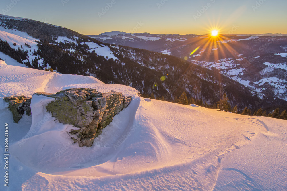 Wall mural sunrise in the carpathian mountains in transylvania , romania, in a cold winter day with valley and 