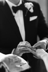 Obraz na płótnie Canvas Groom wears ring on bride's finger. Wedding day