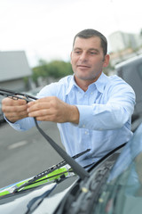 man changing car wipers