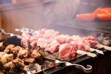 The process of cooking shish kebab on a metal grill in the open air.Grilling shashlik on barbecue...