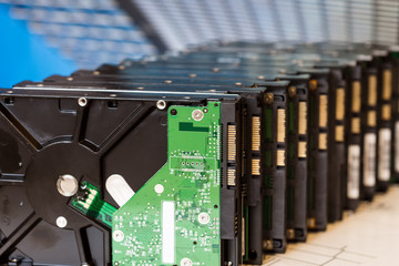 pile of hard drives on blue blurred background