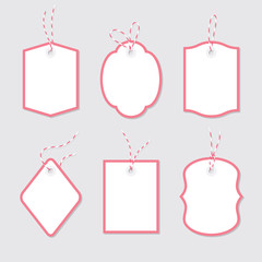 Blank price tags and gift cards tied up with twine bows and ribbons set. Paper labels of different shapes with red border