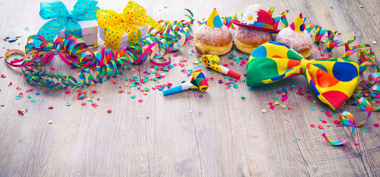 Carnival donuts with paper streamers and party bow tie