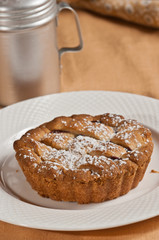 Close up of a freshly baked, homemade, warm, mini blackberry shortcake tart, sprinkled with...