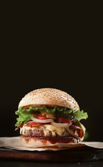 mouth-watering delicious homemade burger used to chop beef on the wooden table.