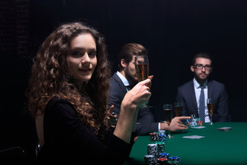 beautiful woman sitting at a table in a casino