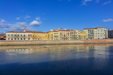 Naklejka premium Picturesque Arno River embankment with colorful old houses in Pisa. Pisa, Tuscany, Italy, Europe.