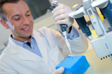 happy young male researcher working in his lab