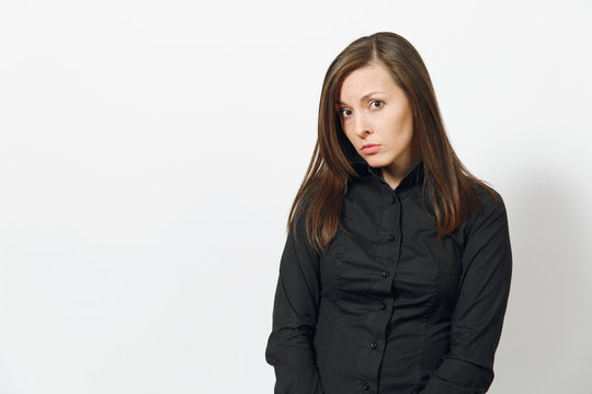 Beautiful serious upset sad caucasian young brown-hair business woman in black classic shirt, skirt isolated on white background close up. Manager, worker, student. Copy space for advertisement.