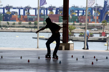 Skaters at a the skate park in Valencia, Spain.   Young and energetic rollerbladers enjoy the vigorous & technical obstacle course at portside recreation marina