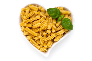 Uncooked fusilli pasta isolated white background.