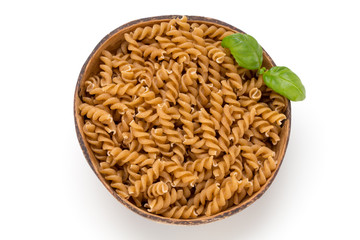 Uncooked wholemeal pasta isolated white background.