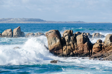 Big waves crashing on rocks coastline