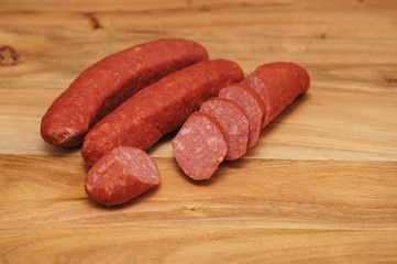 Sliced cabbage sausage on a wooden board
