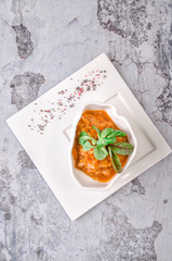 Top view. Stew cabbage decorated parsley on a white plate on a gray concrete background. Restaurant pub kitchen, Vegetarianism Healthy Eating concept.