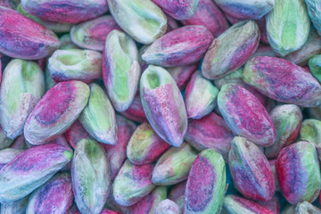Colorful pilled Pistachios nut closeup background. Pistachio nuts macro view backdrop.