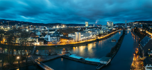 Aerial panoramic view of Zurich skyline at dawn, in the foreground the Limmat river.