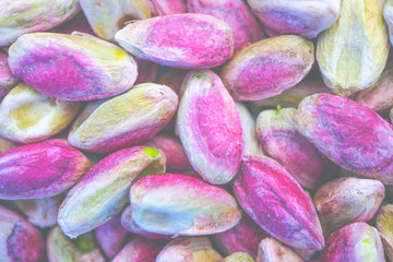 Colorful pilled Pistachios nut closeup background. Pistachio nuts macro view backdrop.