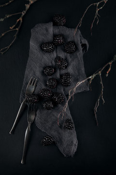 monochrome food picture of blackberries on a napkin and slate plate kitchen table can be used as background