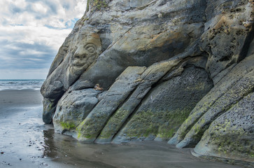Facial rock carving in beach