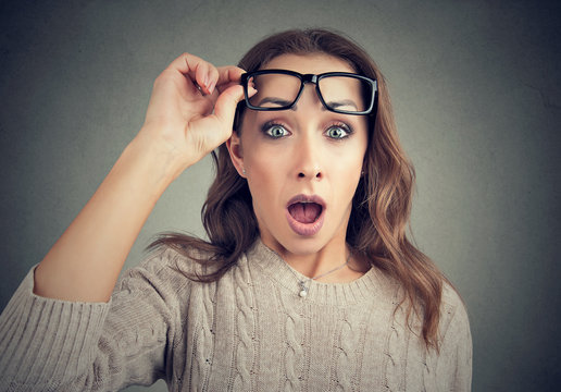 Shocked young woman in eyeglasses