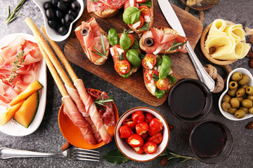 Italian antipasti wine snacks set. Cheese variety, Mediterranean olives, pickles, Prosciutto di...