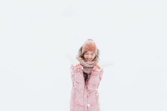 Young positive girl fun and enjoying the first snow of the winter morning, happy beautiful, the picture for the ad,