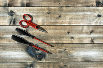 Close up from above of work tools on electrical installations, on an antique wooden table.