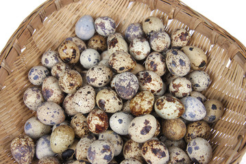 Close up on quail eggs in bamboo weaved container