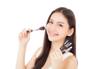 Beauty asian woman applying make up with brush of cheek isolated on white background, beautiful of girl holding blusher, skincare and cosmetic concept.