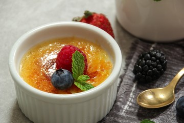 Homemade  Classic Creme Brulee with burnt sugar berry topping, selective focus